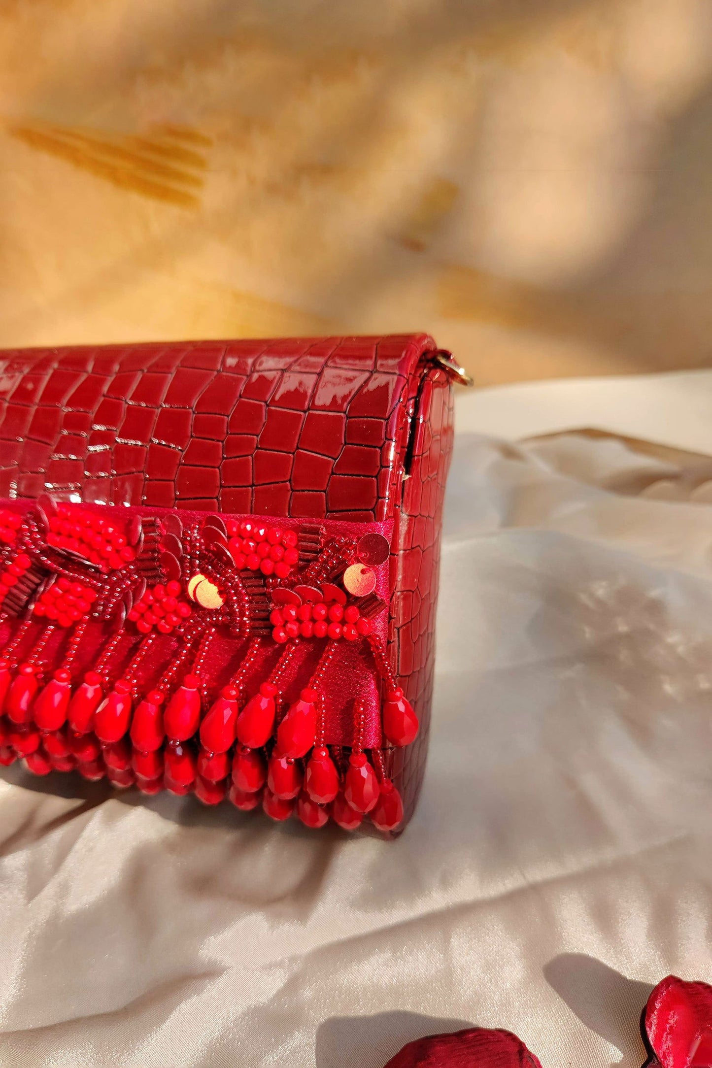 NOORIE RED HANDHELD CLUTCH - www.Shopthatapp.com