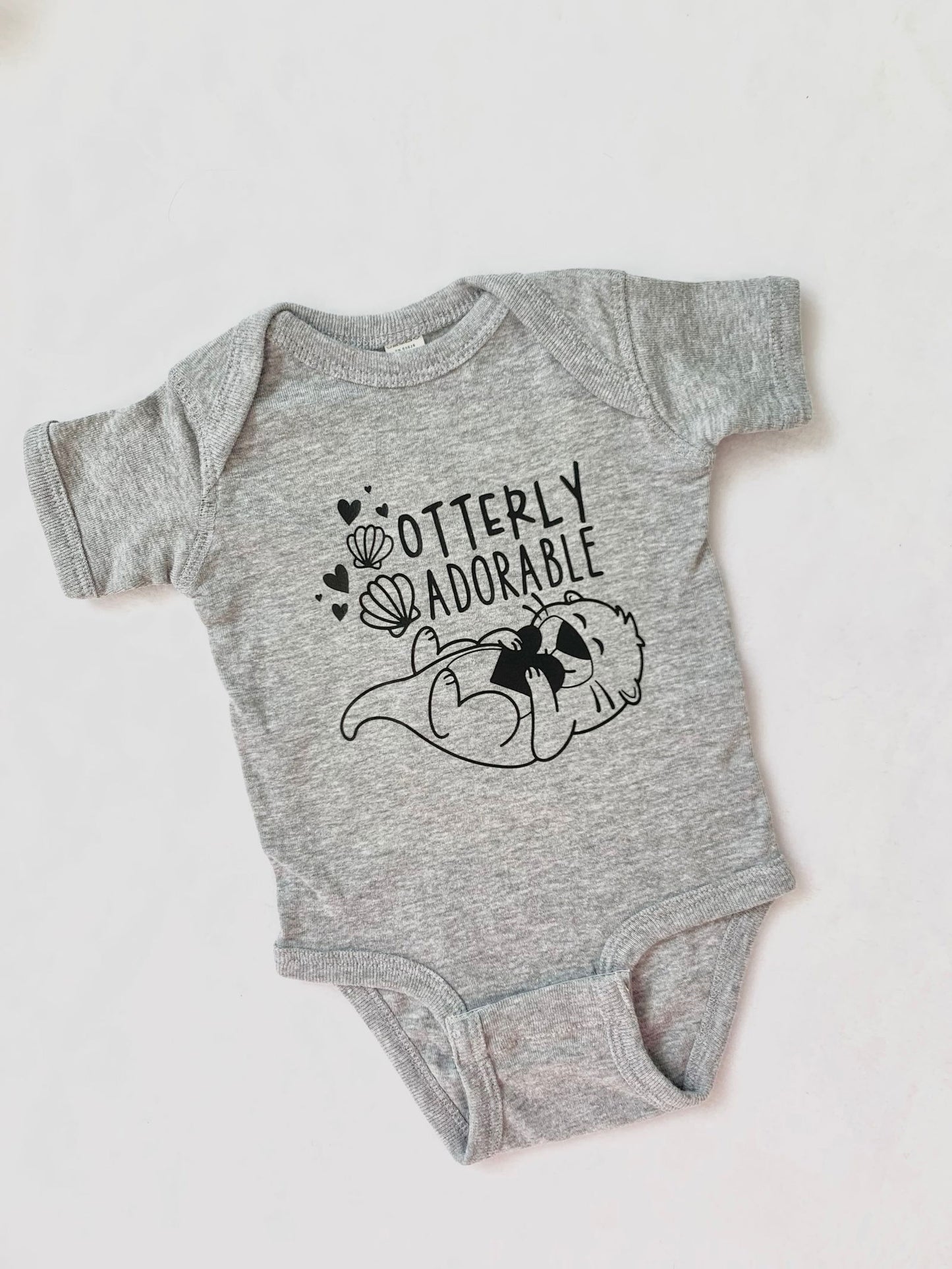 "OTTERLY ADORABLE" BABY ONESIE - www.Shopthatapp.com